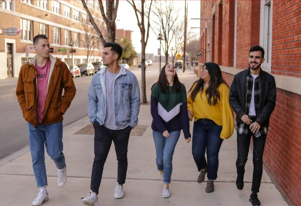 Group of young adults walking down the street together